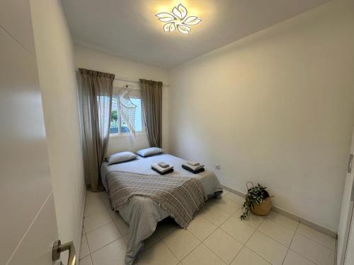 a bedroom with a bed with a butterfly on the ceiling at Liwia beautiful apartment in the first Oceanline in Los Cristianos. in Los Cristianos