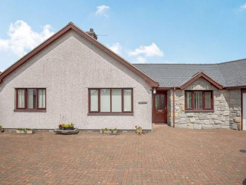 a white house with a brick driveway at Bryn Llan in Bala