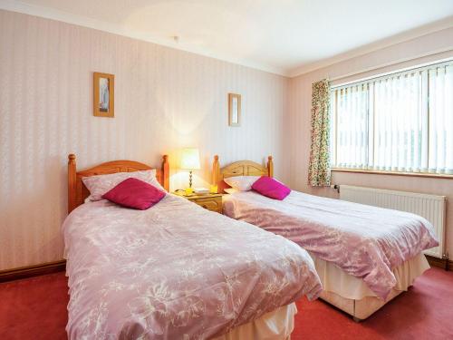two beds sitting next to each other in a bedroom at Bryn Llan in Bala