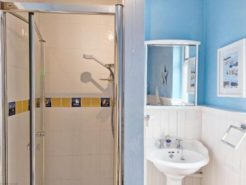 a bathroom with a shower and a sink at Blacksmiths Cottage, Bosham in Bosham