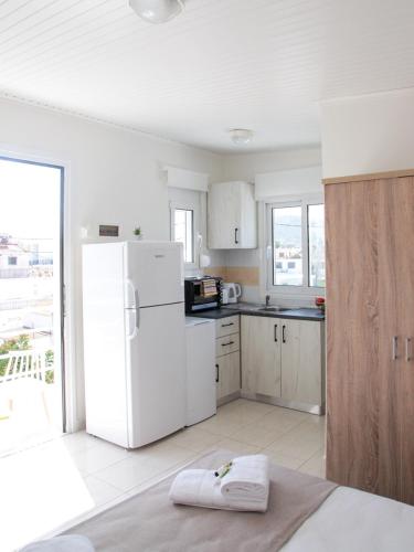 a kitchen with a white refrigerator and a counter top at SunView Studio in Kremasti