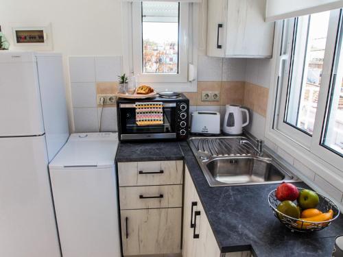 a small kitchen with a sink and a microwave at SunView Studio in Kremasti