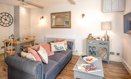 a living room with a couch and a table at Honey Pot, Chipping Campden, parking, garden, late check-out in Chipping Campden
