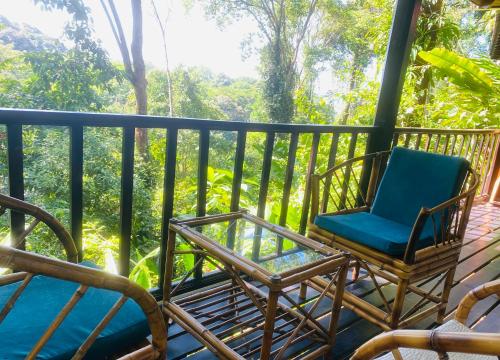 a couple of chairs sitting on a porch at Villas en el Bosque in Ojochal