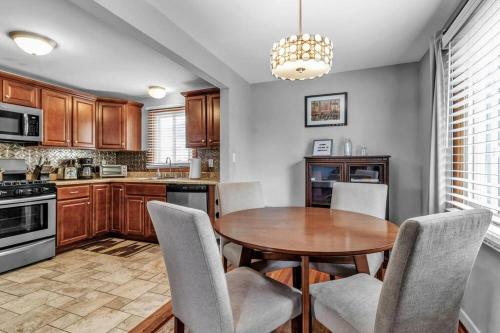 a kitchen with a wooden table and chairs at Gorgeous 2 Queen Bedroom Apartment in North Buffalo with 70 inch TV in Buffalo
