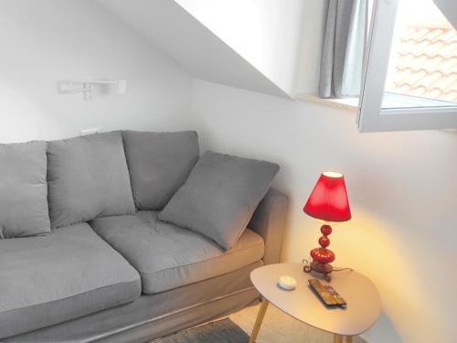 a living room with a couch and a table with a lamp at Lemon&Stone in Korčula