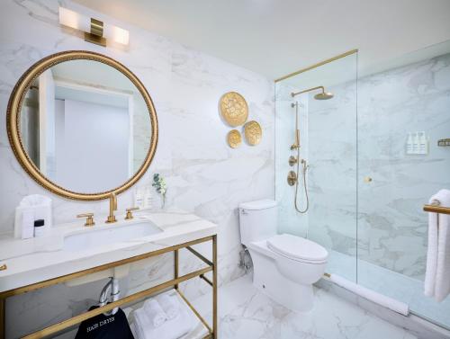 a bathroom with a sink toilet and a shower at Pantages Hotel Toronto Centre in Toronto