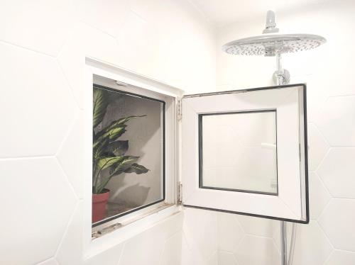 a window in a bathroom with a picture at Lemon&Stone in Korčula