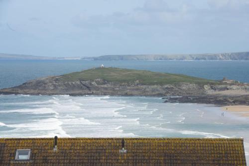 an island in the ocean with waves at 6 The Point, Newquay in Newquay