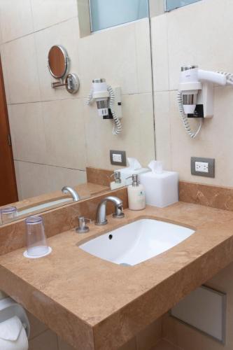 a bathroom counter with a sink and a mirror at Casa Andina Select Zorritos Tumbes in Zorritos