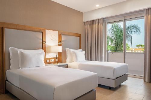 En eller flere senge i et værelse på Wyndham Grand Algarve