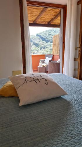 a bed with a pillow sitting on top of it at La Casina di Redinoce in Marciana