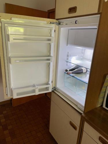 an empty refrigerator with its door open in a kitchen at Ferienwohnung Urban - AHORN -- Meersburg in Meersburg
