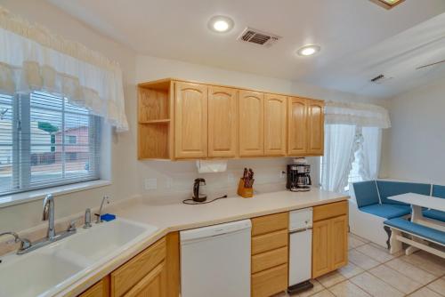 a kitchen with wooden cabinets and a sink at Page Home with Waterfall about 2 Mi to Lake Powell! in Page