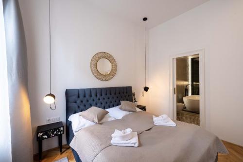 a bedroom with a bed with towels on it at Apartmány Marienhof in Znojmo