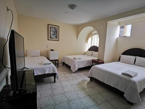 Ένα ή περισσότερα κρεβάτια σε δωμάτιο στο Hotel Bombonaje