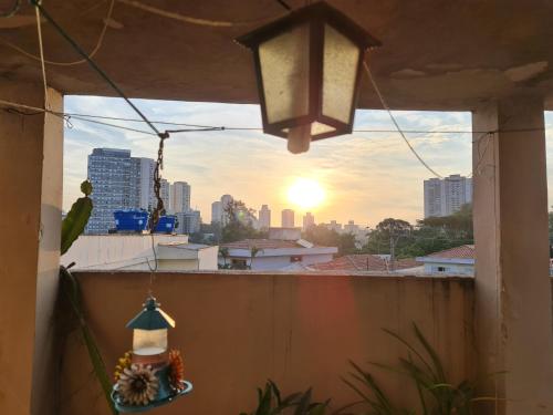 a window with a view of a city skyline at Hostel On Top1 CGH SP Congonhas São Paulo in Sao Paulo