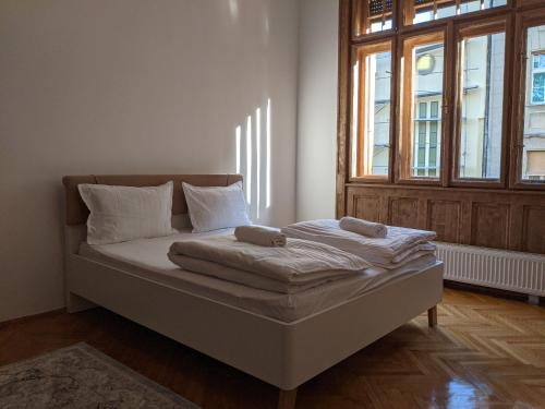 a bed with two pillows on it in a room at Ultra-central apartment in the Loffler Palace in Timişoara