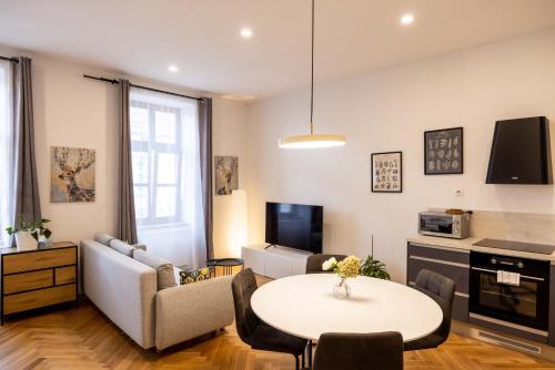 a living room with a couch and a table at Apartmány Marienhof in Znojmo