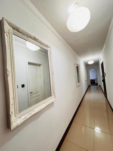 a hallway with a mirror on the wall at R2 Salina Seaview Retreat in Naxxar