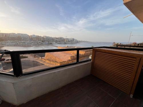 a balcony with a view of the ocean at R2 Salina Seaview Retreat in Naxxar