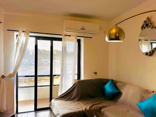 a bedroom with a bed and a large window at R2 Salina Seaview Retreat in Naxxar