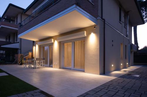 a house with a patio with a table on it at Casa Cate Cervia Centralissima in Cervia