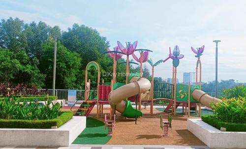 a playground with a slide in a park at Mesahill 2 Bedroom (Deluxe Queen) by DKAY in Nilai in Nilai