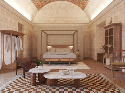 a bedroom with a bed and tables in a room at Palacio Guaqui by Ananay Hotels in Arequipa