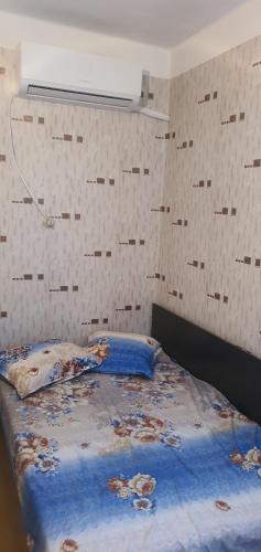 um quarto com uma cama com lençóis azuis em Къща за гости em Razgrad