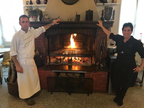 a man and a woman standing in front of a fireplace at Affittacamere Ciccio e Pinolo in La Spezia
