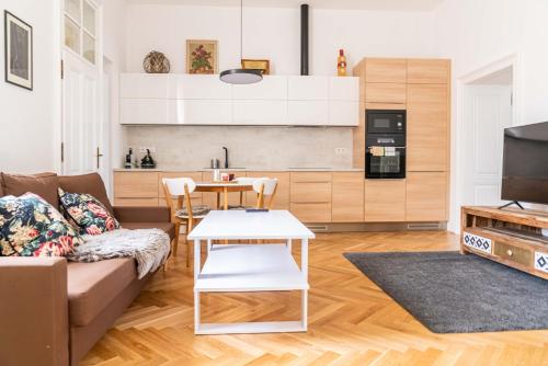 a living room with a couch and a table at Apartmány Marienhof in Znojmo