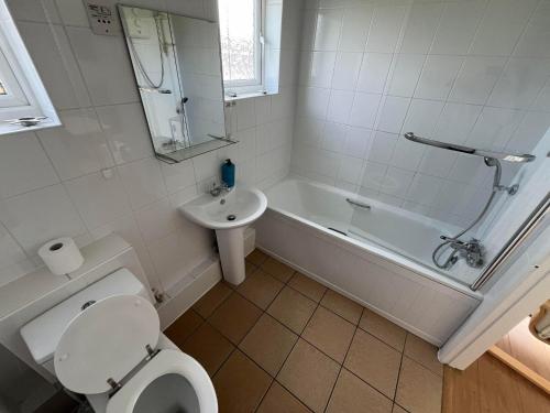 a bathroom with a toilet and a tub and a sink at 26, Two bed chalet on Bermuda holiday park, Hemsby - Sleeps 5, bed linen and towels included - with onsite entertainment and more options close by in Great Yarmouth