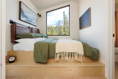 a bedroom with a bed and a large window at Outbound Stowe in Stowe
