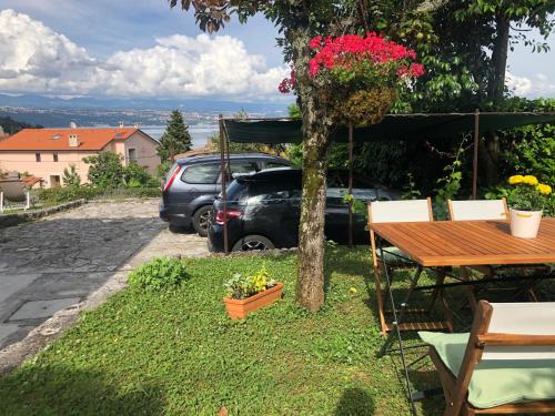 a table and a car parked in a yard at Perla Apartments Opatija - apartments with sea view in Opatija