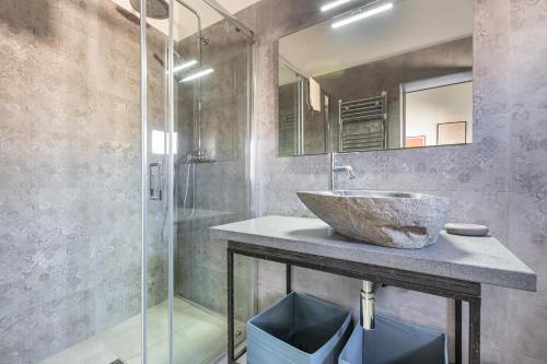 a bathroom with a sink and a glass shower at Casa Kalè by BarbarHouse in Gallipoli