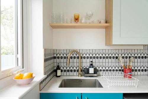 a kitchen counter with a sink and a window at The Lorelei Chic Urban Retreat with Terrace in Brighton in Brighton & Hove