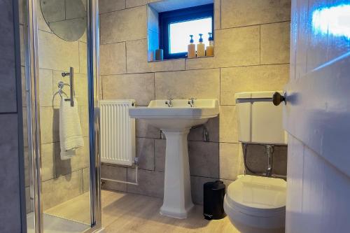 a bathroom with a sink and a toilet at Cosy Coastal Retreat-Dog Friendly in Worle