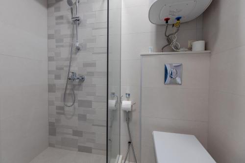 a bathroom with a glass shower with a toilet at The SPOT apartments - Orbi Beach Tower in Batumi