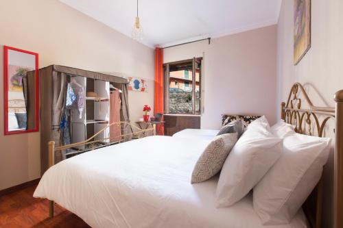 a bedroom with a white bed with white pillows at BSisters in Torre del Greco