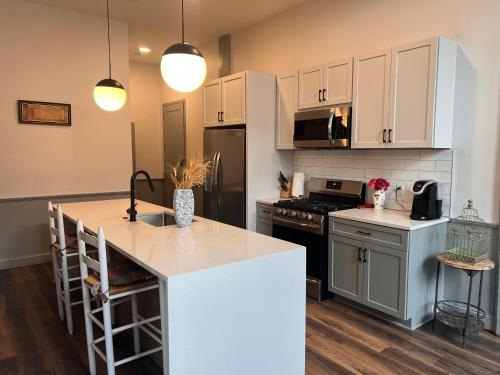 a kitchen with white cabinets and a counter top at Prime 2BR Condo Historic Morris Ave, Downtown Birmingham in Birmingham
