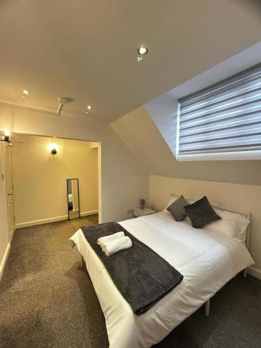 Schlafzimmer mit einem großen weißen Bett und einem Fenster in der Unterkunft Lovely 5BR Home in Manchester. Close to the City in Manchester