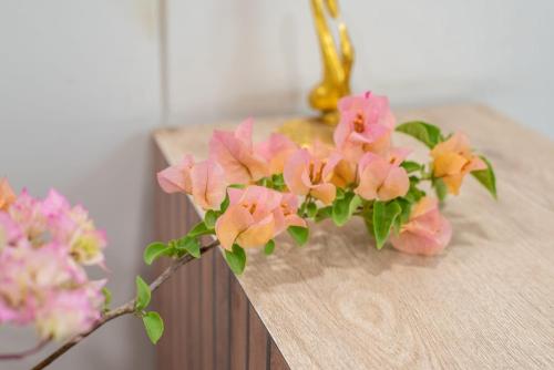 a bunch of pink and orange flowers on a table at The Setu Hotel & Resorts in Faridabad