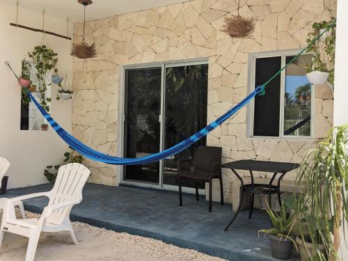 a house with a blue rope around a table and chairs at Casa Foto Estudios in El Cuyo