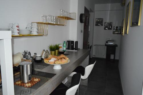 a kitchen with a table with a plate of food on it at B&B SERENITY2024 in Rome
