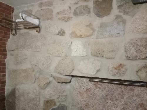 a stone wall with a toilet paper dispenser on it at El Canchal de Eladia in Valdeverdeja
