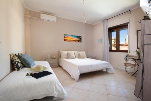 a bedroom with two beds and a couch in it at BSisters in Torre del Greco