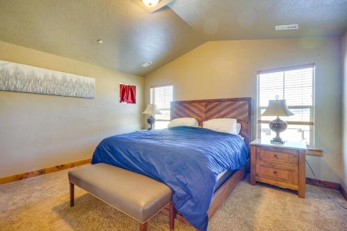 a bedroom with a bed and a table and a chair at Townhome with Outdoor Pool Access 6 Mi to Park City in Heber City