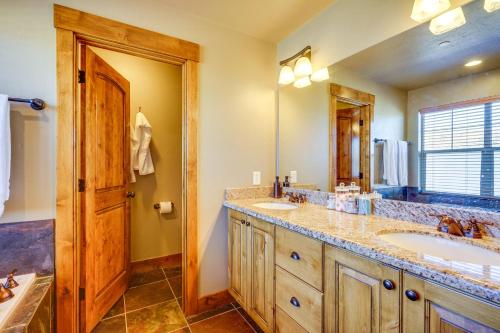 a bathroom with two sinks and a large mirror at Townhome with Outdoor Pool Access 6 Mi to Park City in Heber City
