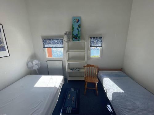 - une chambre avec 2 lits, une chaise et un bureau dans l'établissement Villa climatisée proche plage avec parking au Cap d'Agde - FR-1-723-144, au Cap d'Agde